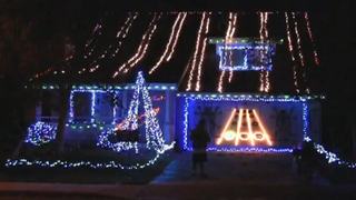 Guitar Hero Played On Side of House in Christmas Lights Invents New Class of Neighborhood Competition